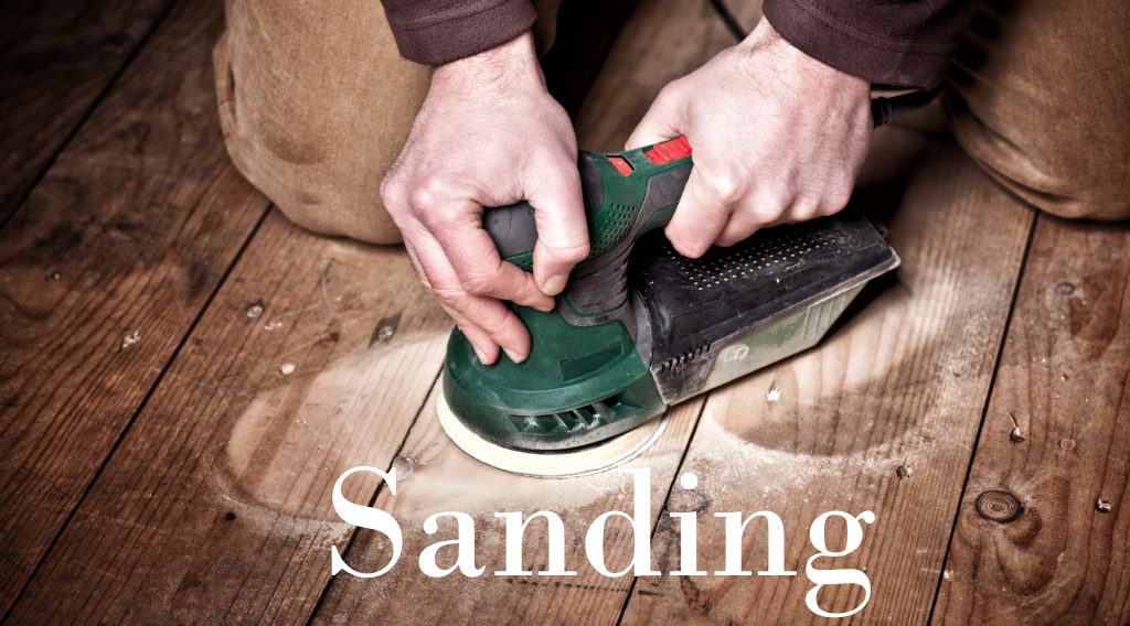 closeup of carpenter work with sander on wood floor